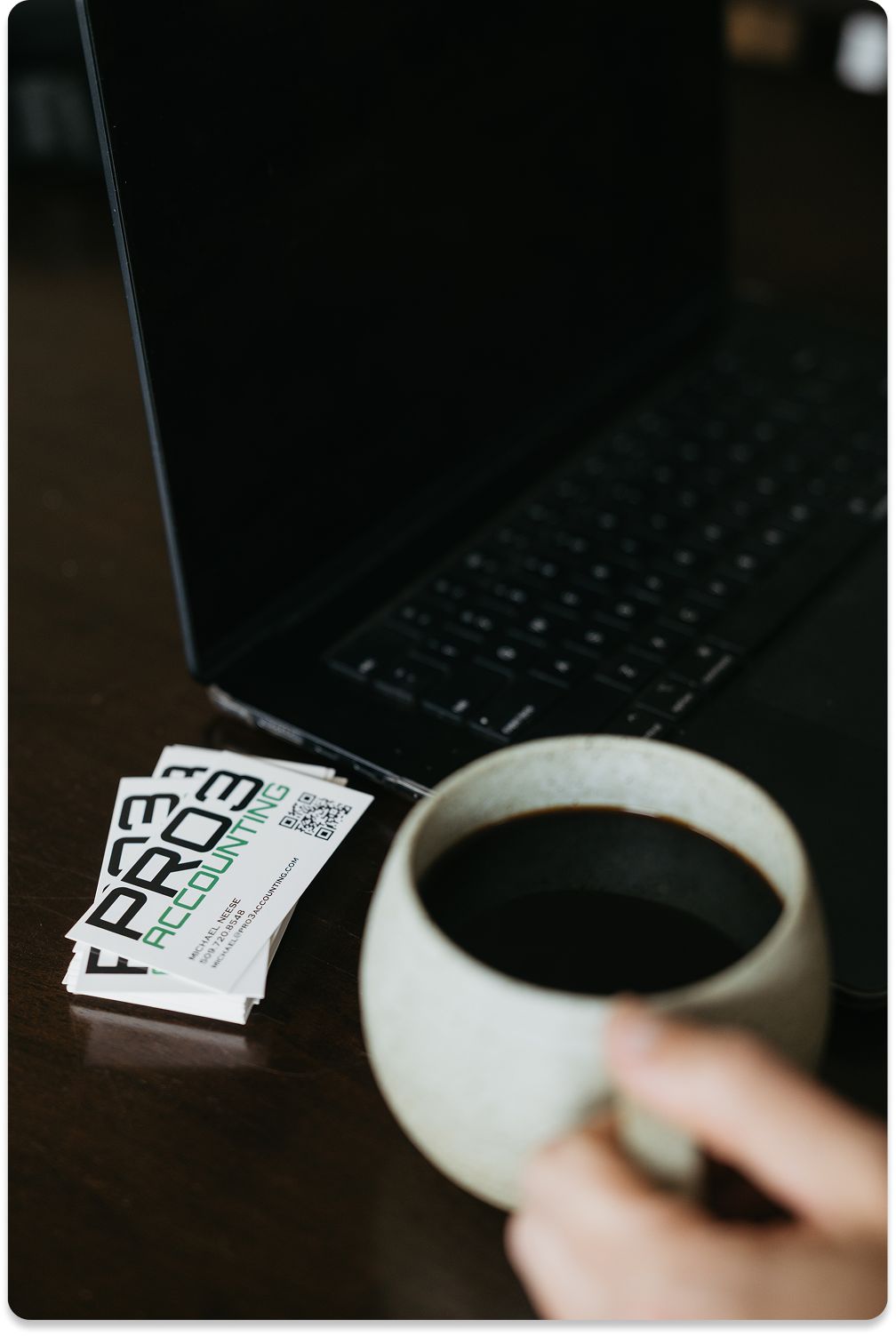 Pro3 business card next to a coffee